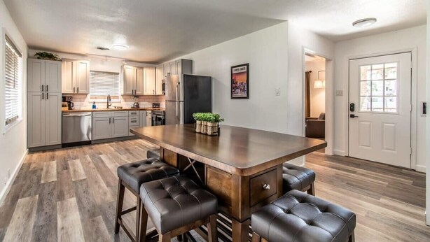 A modern kitchen with a central island, bar stools, and built-in appliances. - Gulfside Getaway Awaits (Corpus Christi)