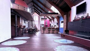 A spacious interior with a long dining area, kitchen, and bar area. - 8 Tents at Niagara Retreat Center (Niagara Falls)