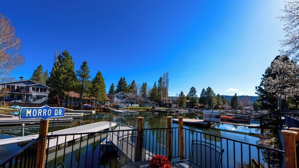 A marina with docked boats, a clear blue sky, and residential houses in the background. - Waterfront  Hot Tub,Game room, Tahoe Keys MV25 (South Lake Tahoe)