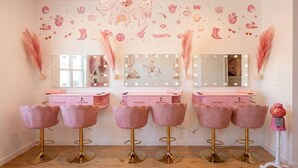 A vanity area with mirrors, lights, and pink chairs. - Pink Longhorn + Glam Getaway + Walk to UT  Downtown Pink Longhorn (Austin)