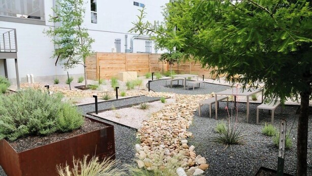 A landscaped outdoor area with seating, a gravel path, and various plants. - Pink Longhorn + Glam Getaway + Walk to UT  Downtown Pink Longhorn (Austin)
