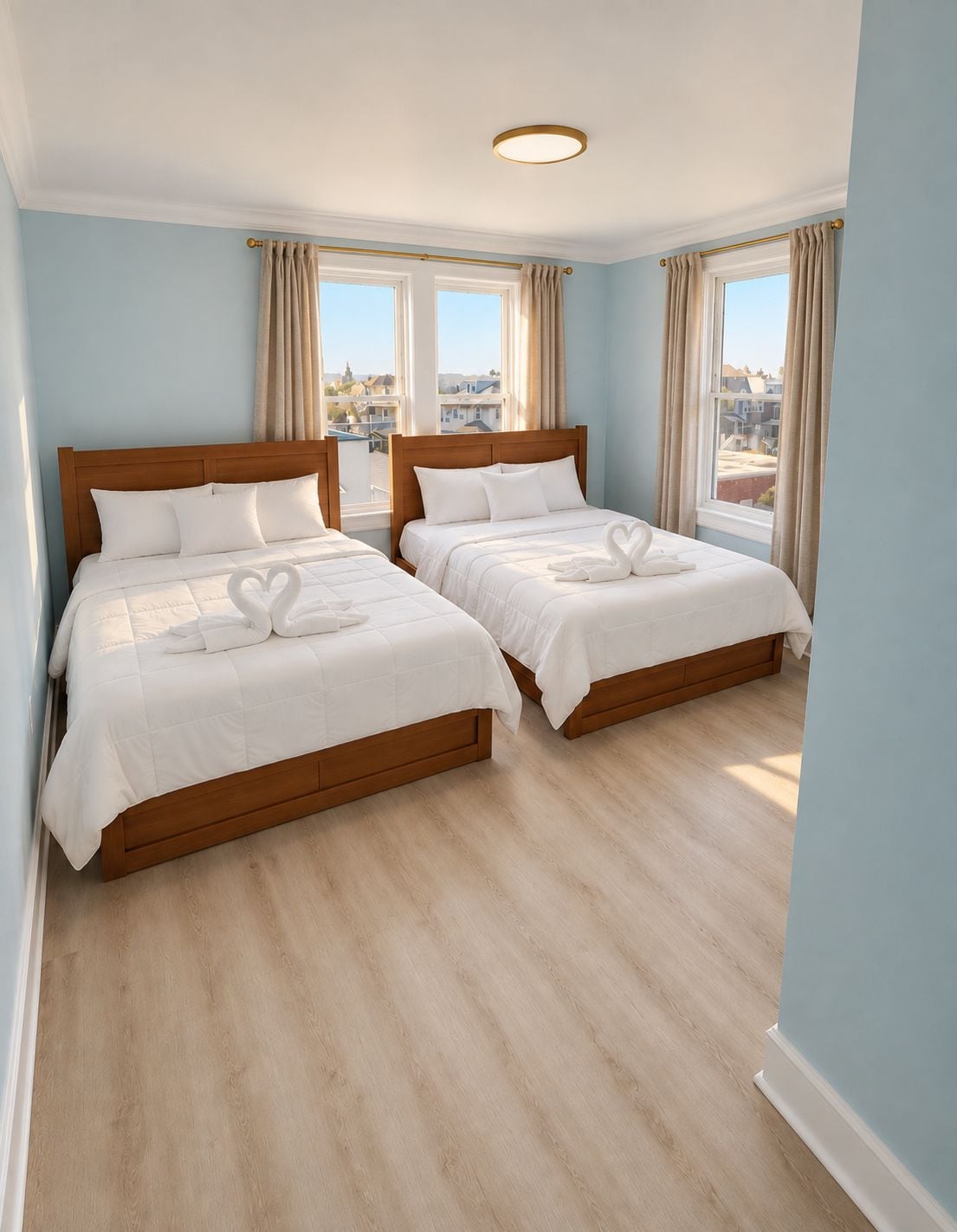 A hotel room with two beds, a wooden headboard, and a view of the city through large windows.