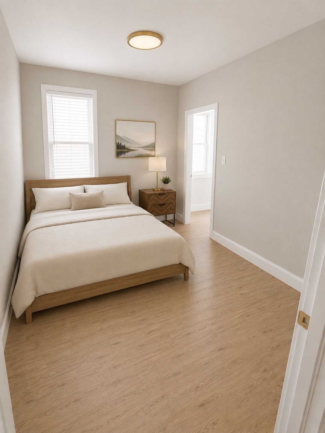 A bedroom with a bed, bedside table, lamp, and a painting on the wall.