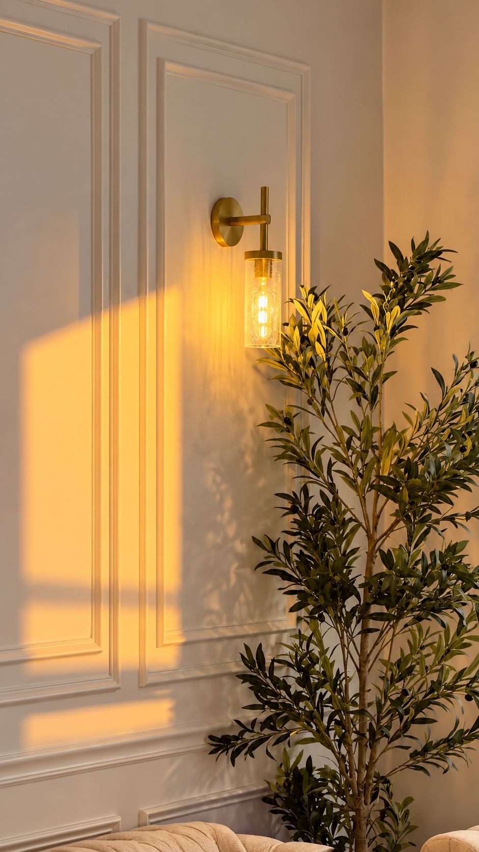 A room with a wall-mounted light fixture and a potted plant.