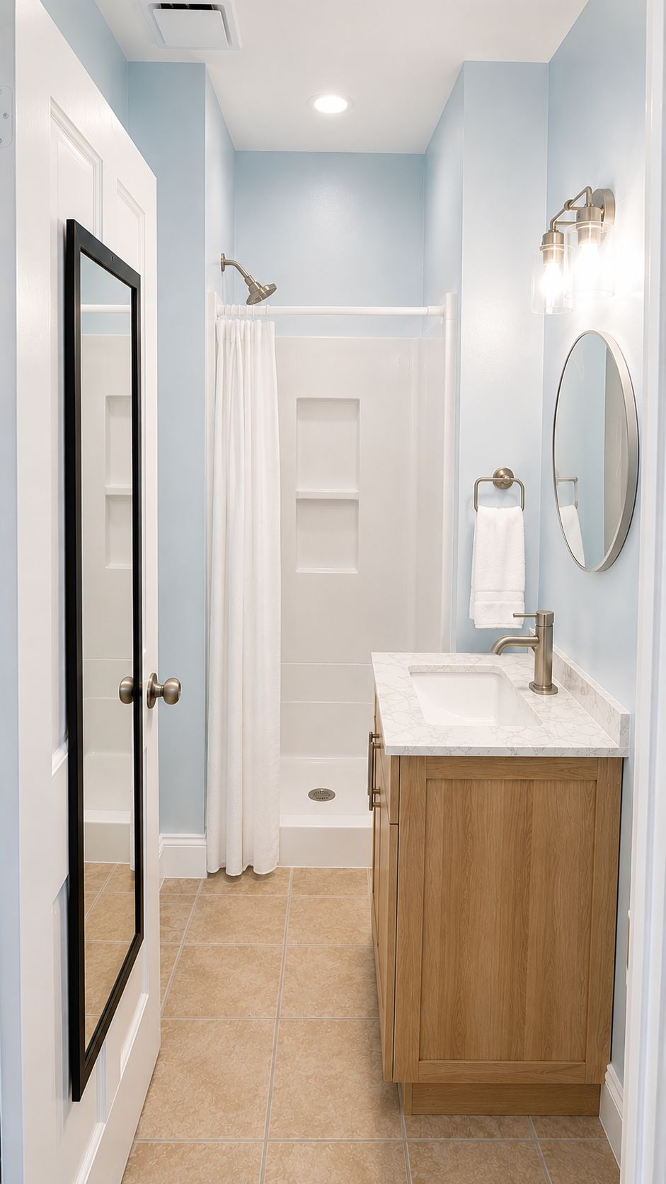 A bathroom with a shower, a sink, a mirror, and a door.