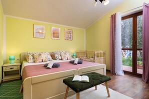 A bedroom with a bed, bedside tables, a window with curtains, and a view of the outdoors. - Villa Natalie (Istria - Rakalj) (Rakalj)