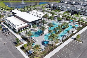 A modern hotel with a swimming pool, parking, and a view of the surrounding neighborhood. - Luxury Resort Estate Near Disney, Convention Center,  ESPN Wide World of Sports (Orlando)