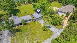 An aerial view of a residential property with a house, a garage, and a driveway. - Table Rock Lakefront Studio w Access_Private Hot Tub_Free Daily Tickets (Hollister)