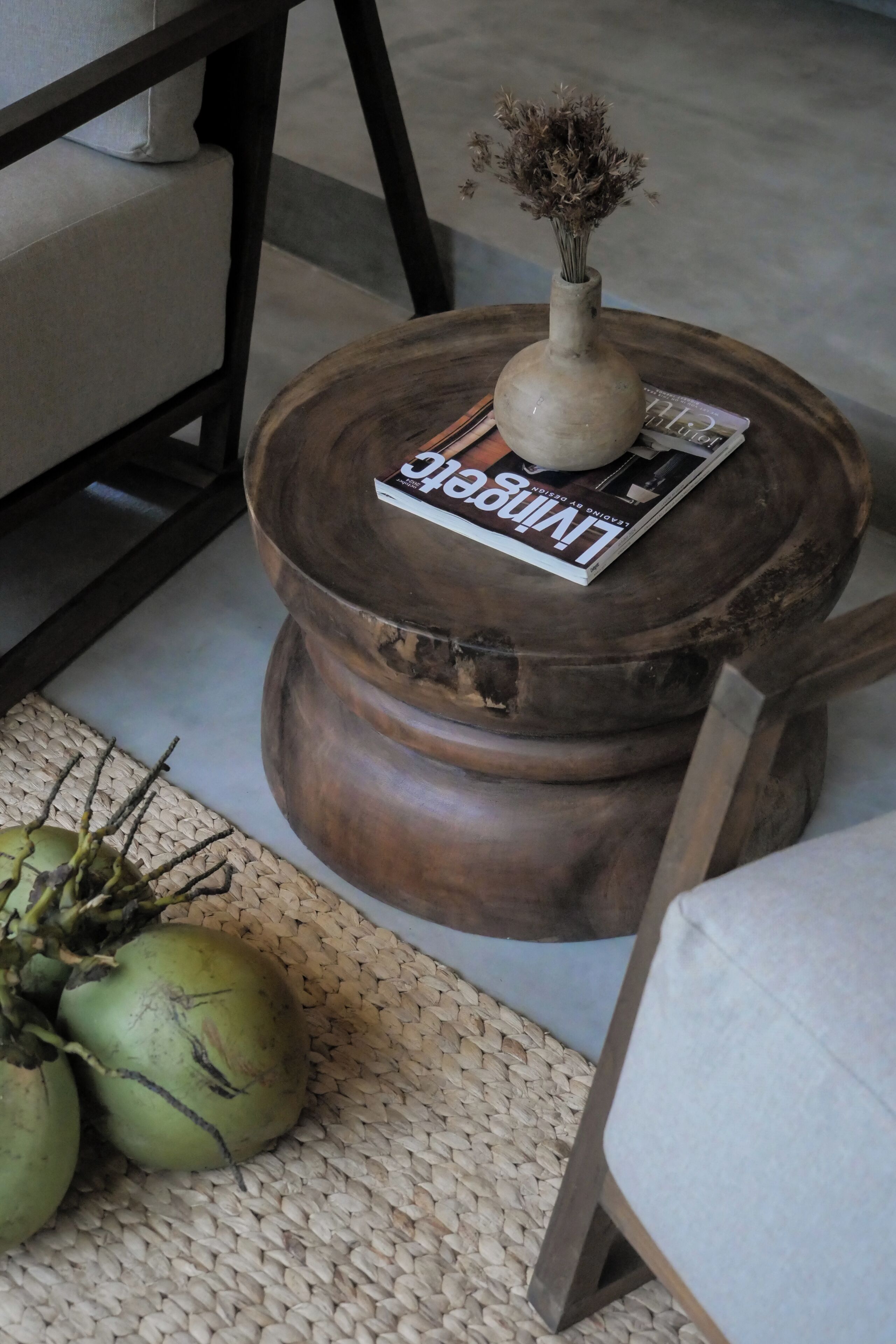 A rustic wooden table with a vase and a magazine.