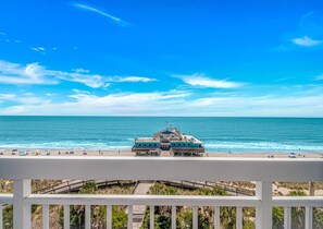A beachfront hotel with a pier, a view of the ocean, and a white balcony railing. - Yachtsman S703A Studio (Myrtle Beach)