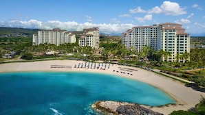 A resort with beachfront villas, a sandy beach, and a clear blue sea. - Amazing Private Beach Resort on West Side of Oahu (Kapolei)