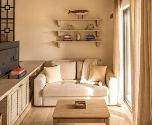Deluxe Room, Patio, Pool View | Living area