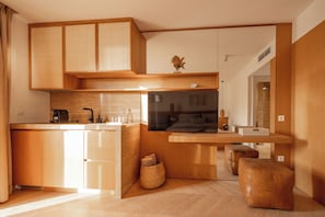 A modern kitchen with wooden cabinets, a built-in oven, and a breakfast bar. - Mamei Boutique Villa (Kotor)