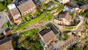 A coastal village with traditional architecture, terraced houses, and a winding road leading to the sea. - YAOJIA XINGLUOHAIYE RESORT (Taizhou)