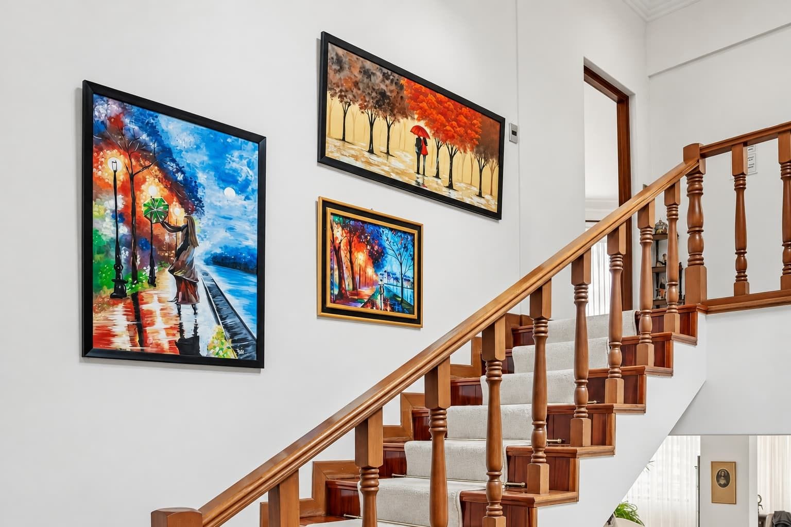 A staircase with wooden balusters and a handrail, leading to an upper floor.