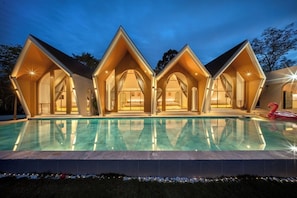 A modern villa with a pool, featuring a unique architectural design with multiple gabled sections and large windows. - Winvilla Pattaya (Bang Lamung)