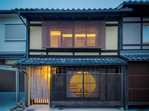 A traditional Japanese building with a wooden gate, sliding doors, and a tiled roof. - Wakaba Machiya House (Kyoto)