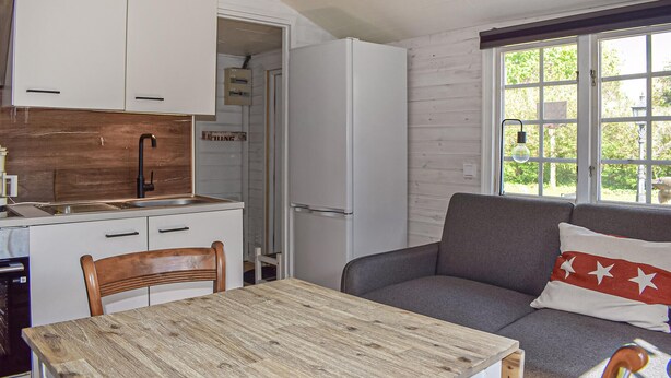 A compact kitchen with white cabinets, a wooden countertop, and a built-in sink. - Cozy home in Gärds Köpinge with WiFi (Gärds Köpinge)
