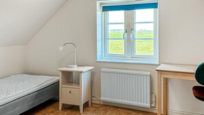A bedroom with a window, a desk, a radiator, and a bed. - Amazing home in Tomelilla with WiFi (Tomelilla)