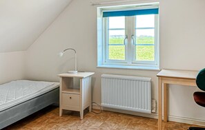 A bedroom with a window, a desk, a radiator, and a bed. - Amazing home in Tomelilla with WiFi (Tomelilla)