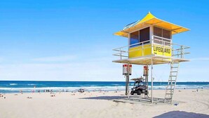 A lifeguard tower on a beach with clear skies. - Beach Holiday at Oracle Level 7 (Gold Coast)