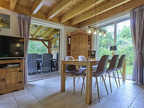 A wooden dining area with a table and chairs, a television, and a sign reading 'villa for you'. - Home in a private park with a spacious garden (Epe)