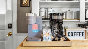 A coffee station with Keurig and a coffee maker, coffee mugs, and a coffee-themed sign. - Winter Harbor Haven - NEW! (Winter Harbor)