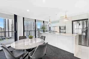 A modern kitchen with a stainless steel refrigerator, a built-in oven, and a microwave. - Relax at the Beach at Oracle Level 10 (Gold Coast)