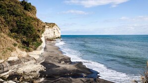 A coastal landscape with cliffs and a beach.