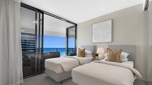 A hotel room with two beds, a balcony with a view, and a large window. - Ocean Getaway at Oracle Level 28 (Gold Coast)