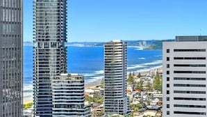 A coastal cityscape with high-rise buildings, a beach, and a clear blue sky. - Beach Breeze Skyhome at Oracle Level 32 (Gold Coast)