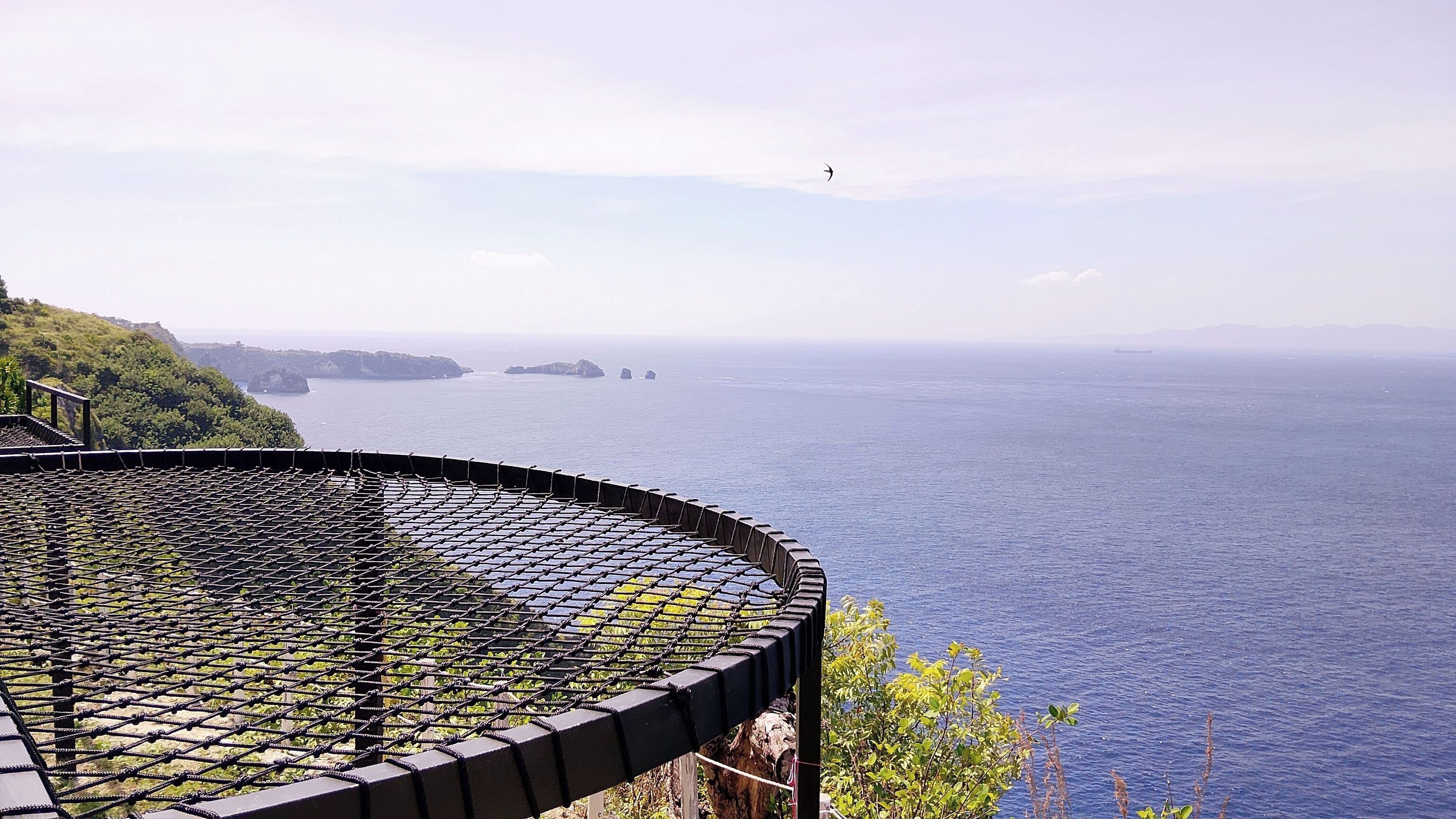 A coastal view with a circular viewing platform overlooking the sea.