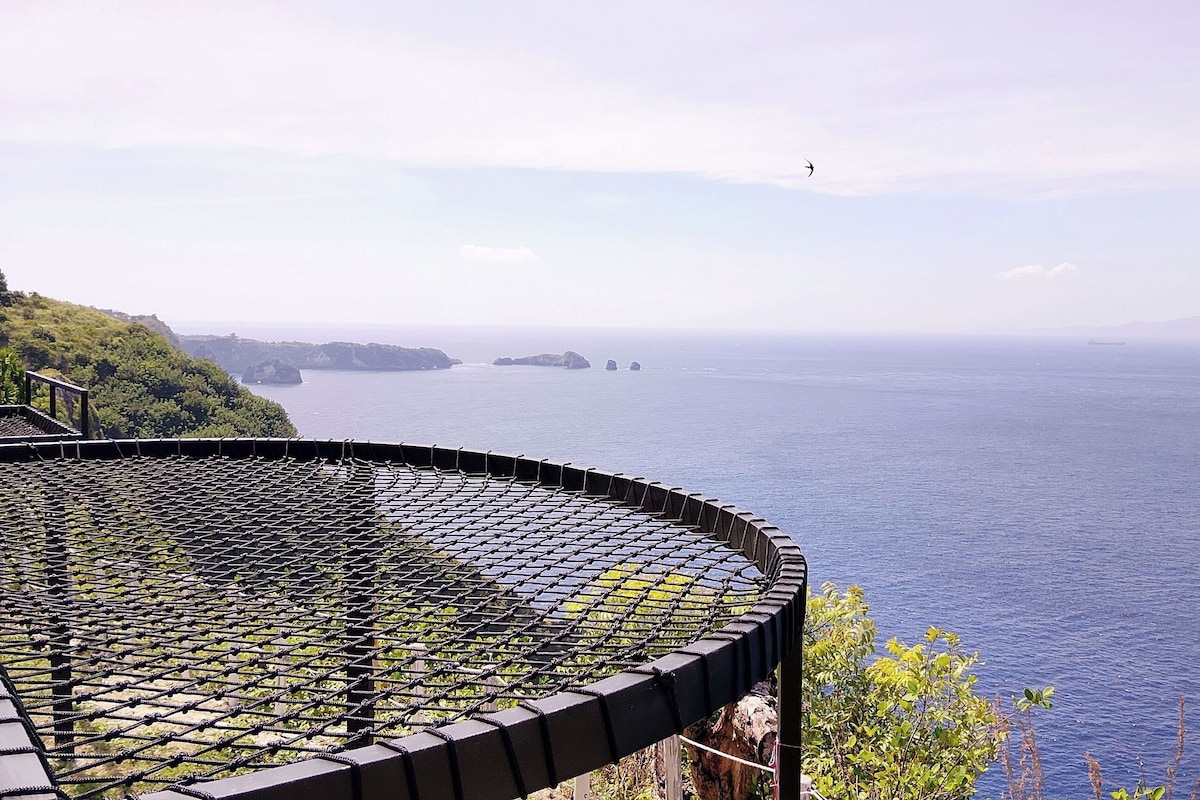 A coastal view with a circular viewing platform overlooking the sea.