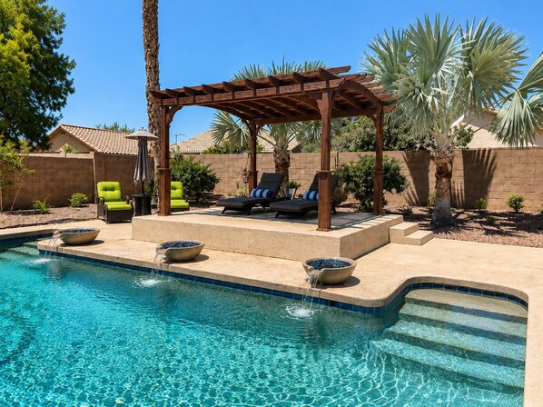 A pool area with a pergola, lounge chairs, and a clear blue pool. - Saltwater Pool, Walk to Pickleball, North Phoenix Retreat,  Norterra Shopping. (Phoenix)