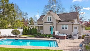 A two-story house with a swimming pool, a covered patio, and a hot tub. - Heated Pool and Hot Tub near Downtown Lake Geneva! (Lake Geneva)