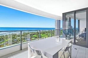 A balcony with a view of the ocean and a cityscape. - Luxe by the Beach at Oracle Level 13 (Gold Coast City)