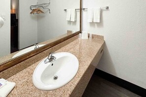 A bathroom with a white sink, a mirror, and a towel rack. - 1 King Bed | Smoking, Micfridge (Mesa)