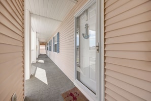 A corridor with a door, a welcome sign, and a doormat. - Tee Times, Poolside Vibes! Myrtle Beach Retreat (Myrtle Beach)