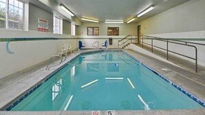 An indoor swimming pool with a 5 ft depth marker, a warning sign, and a staircase leading to an upper level. - Cozy Queen Bed Room|Pool|Free WiFi (MERIDIAN)