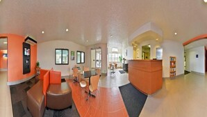 A hotel lobby with a reception desk, seating area, and a large window. - Cozy Queen Bed Room|Pool|Free WiFi (MERIDIAN)