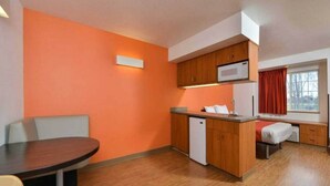 A compact room with a kitchenette, a dining area, and a small bed. - Cozy Queen Bed Room|Pool|Free WiFi (MERIDIAN)