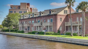 A waterfront hotel with brick buildings, balconies, and a canal. - Poolside Fun! Waterfront Gem Near San Marco Square (Jacksonville)