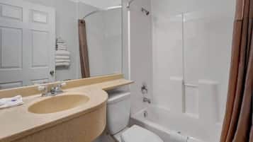 A bathroom with a sink, toilet, and shower.