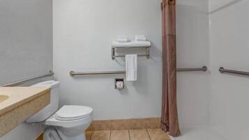 A bathroom with a toilet, a sink, a towel rack, and a shower curtain.
