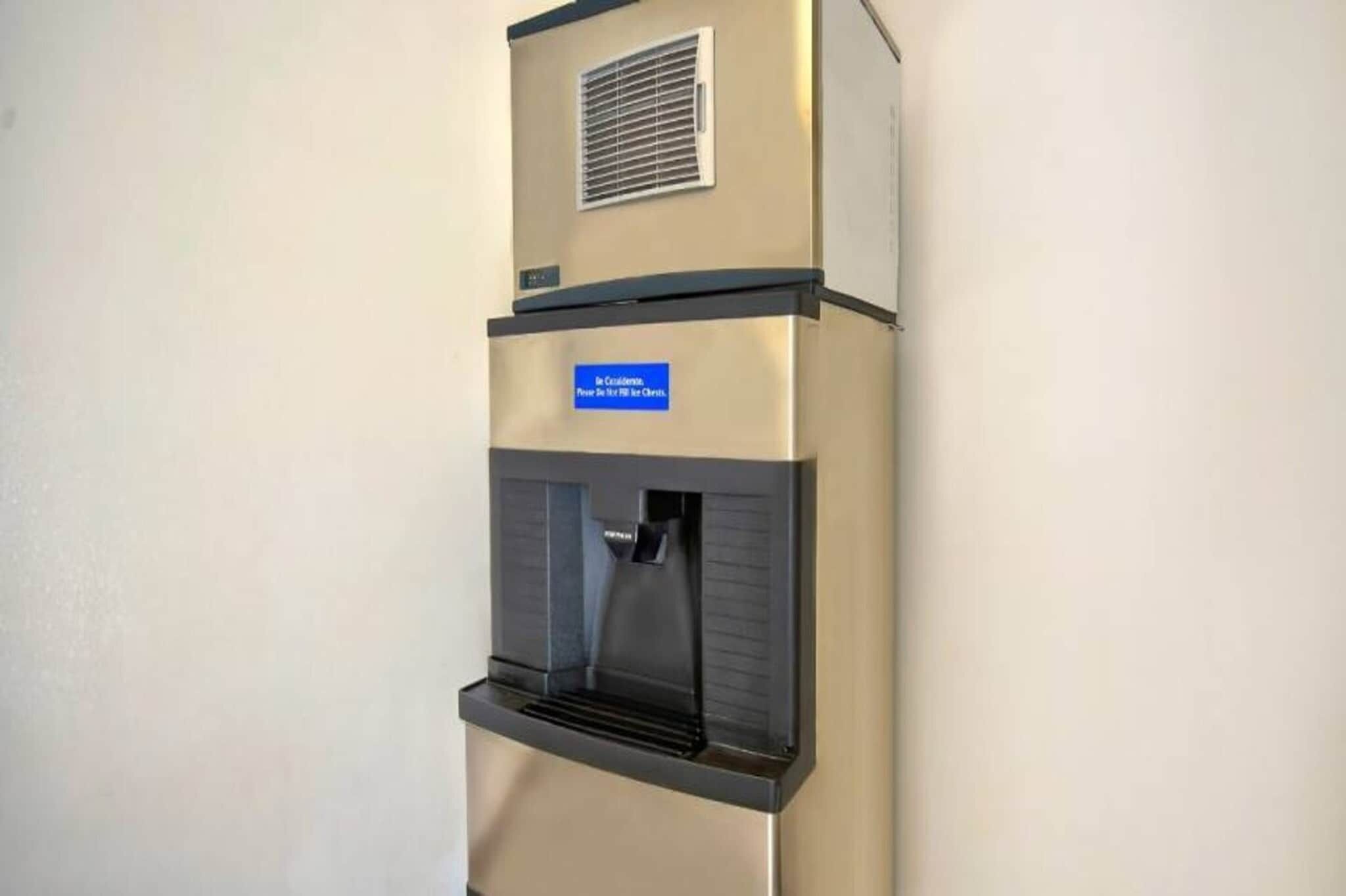 Ein Wasserautomat mit einem Schild, einer Lüftung und einem Bedienfeld.