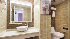 A bathroom with a white sink, a mirror, a toilet, and a towel rack. - Summer Inn Sanya (Sanya)