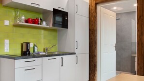 A kitchen with white cabinets, a microwave, and a sink.