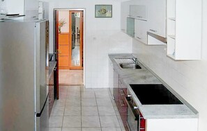 A modern kitchen with stainless steel appliances, a sink, and a tiled floor. - 4 bedroom amazing apartment in Supetar (Supetar)
