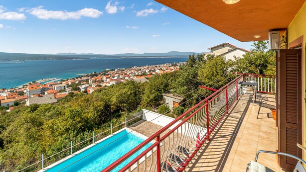 A balcony with a pool overlooking a coastal town. - Lovely apartment in Crikvenica (Crikvenica)