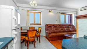 A compact living space with a kitchenette, dining area, and a sofa. - Lovely apartment in Crikvenica (Crikvenica)